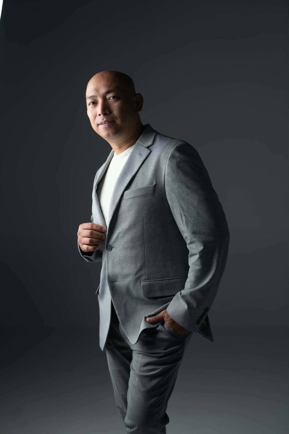 Jover Loberial, BSN, RN standing in a grey suit