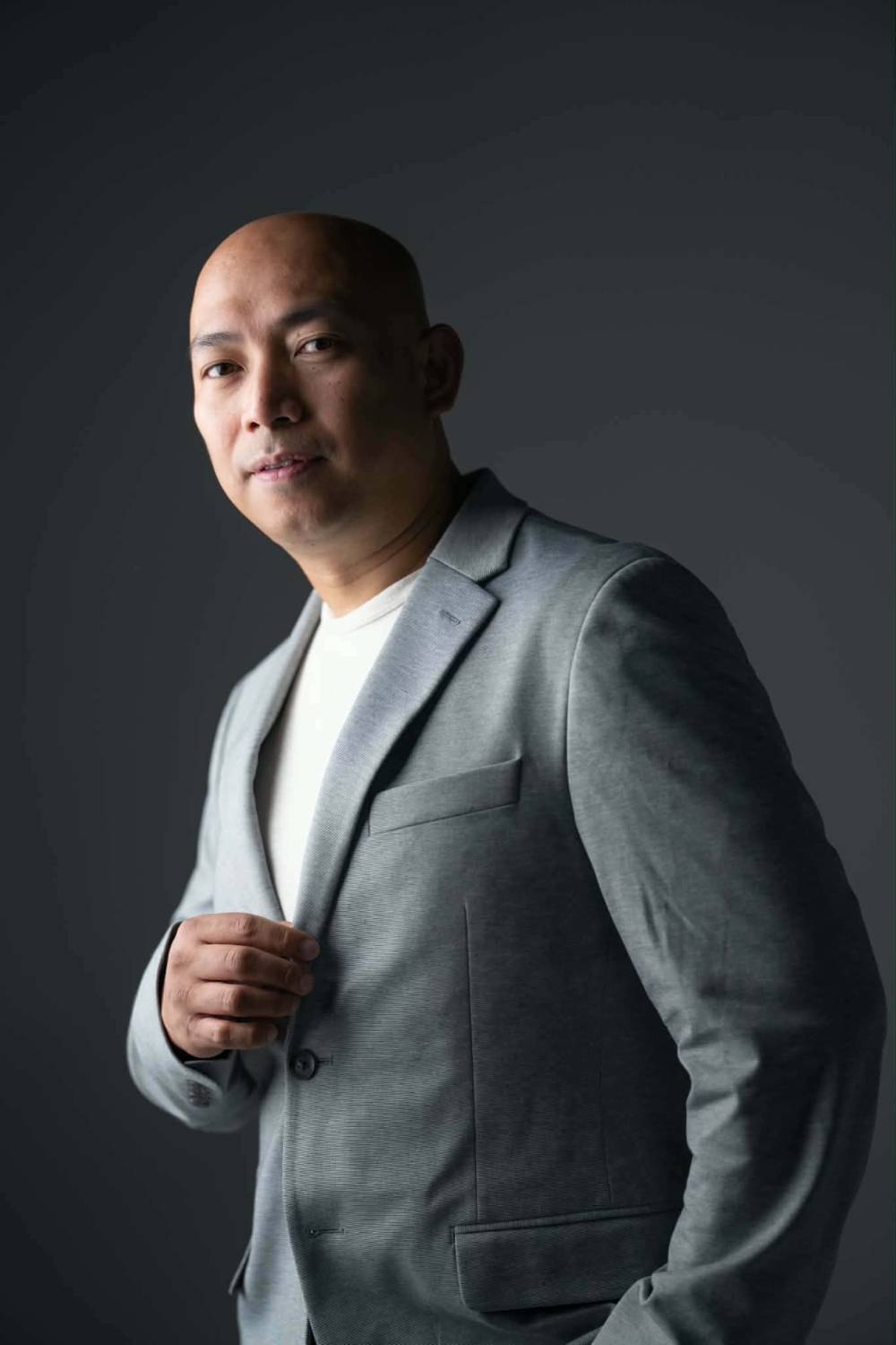 Portrait of Jover Loberial, BSN, RN in a light grey blazer